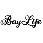 Large steel wall art with the words 'Bay Life' cut out in an elegant cursive font. Painted black, it features smooth lines capturing a coastal theme.